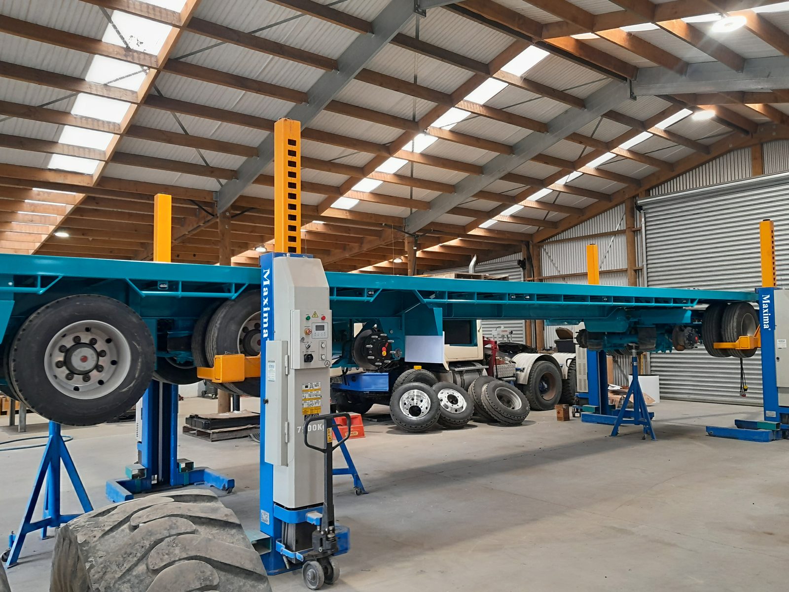 Trucks up on the hoists inside the AIS Methven workshop